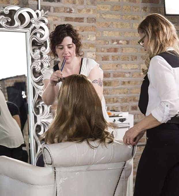 stylists working with hair extensions